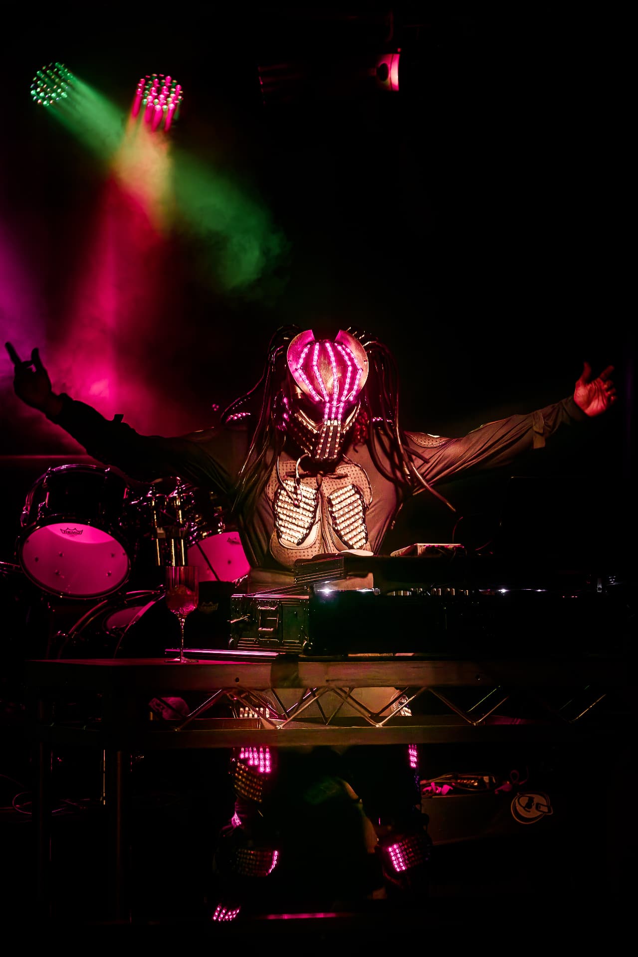 LED-masked DJ performing on stage
