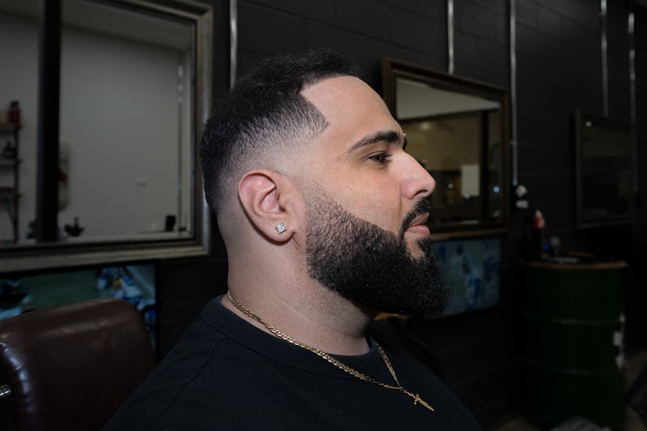 Client in three-quarter profile with a sculpted beard