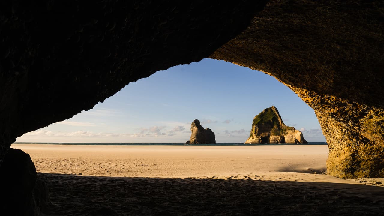 Beach framed by a cave opening