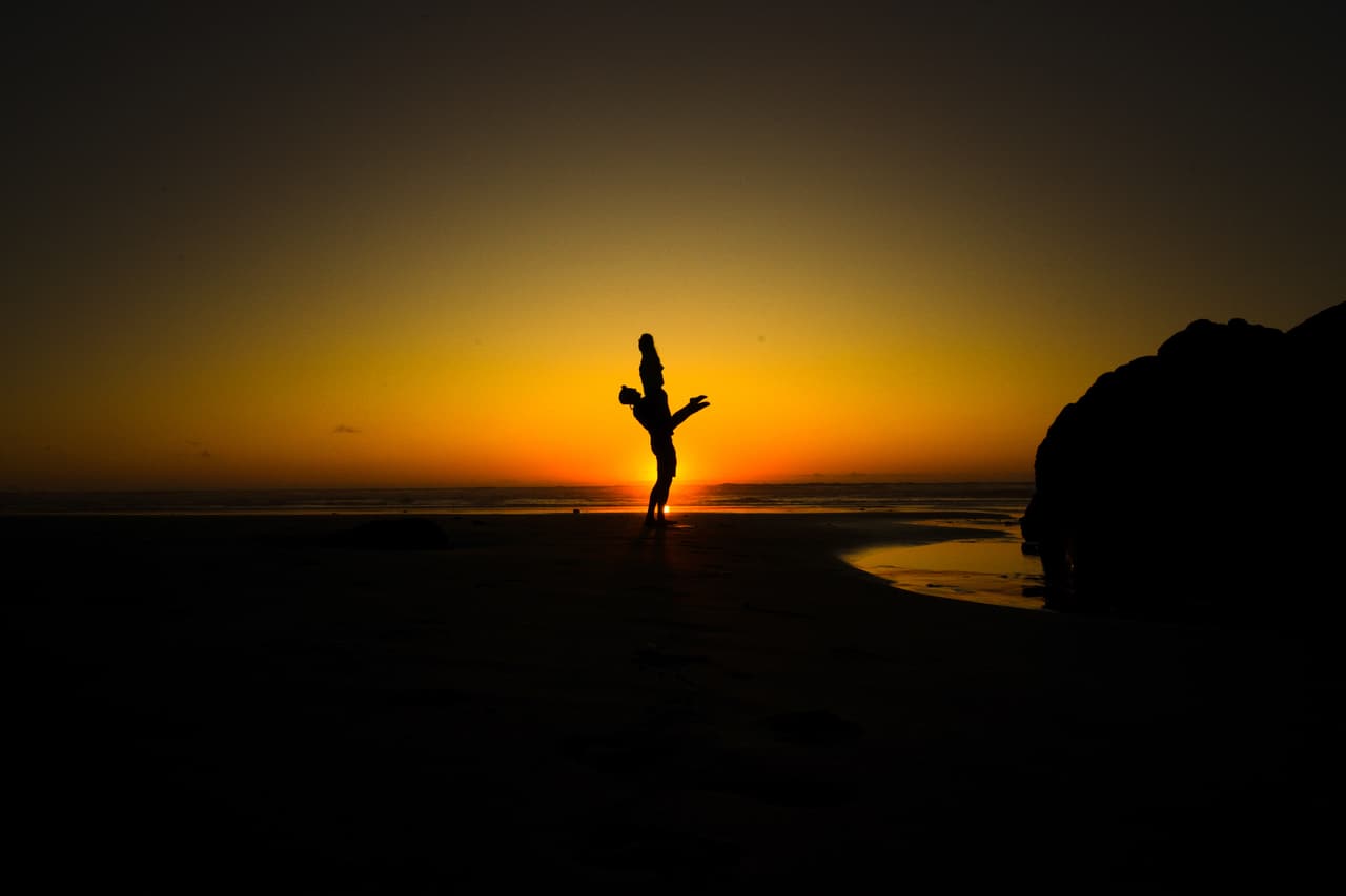 Silhouette in an acrobatic pose at sunset