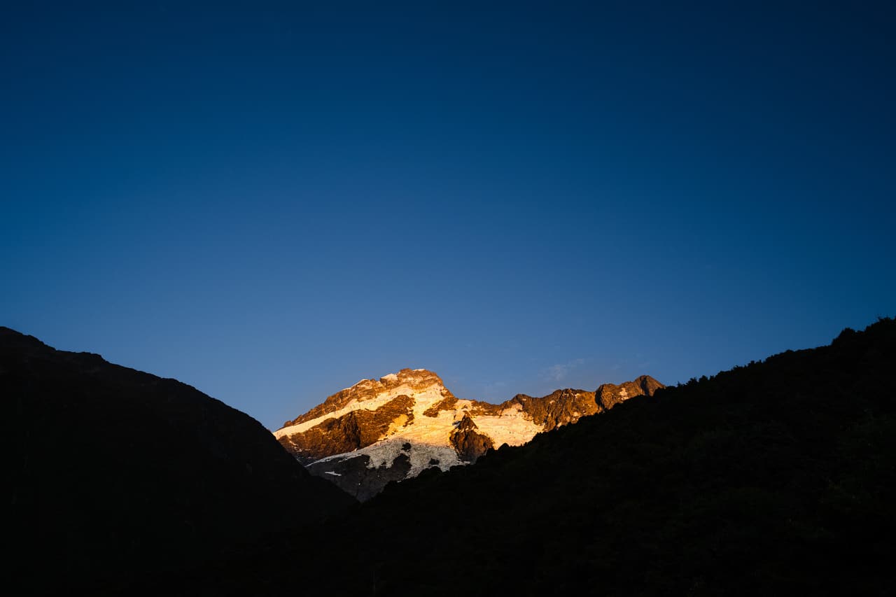 Mountain peak lit by first light