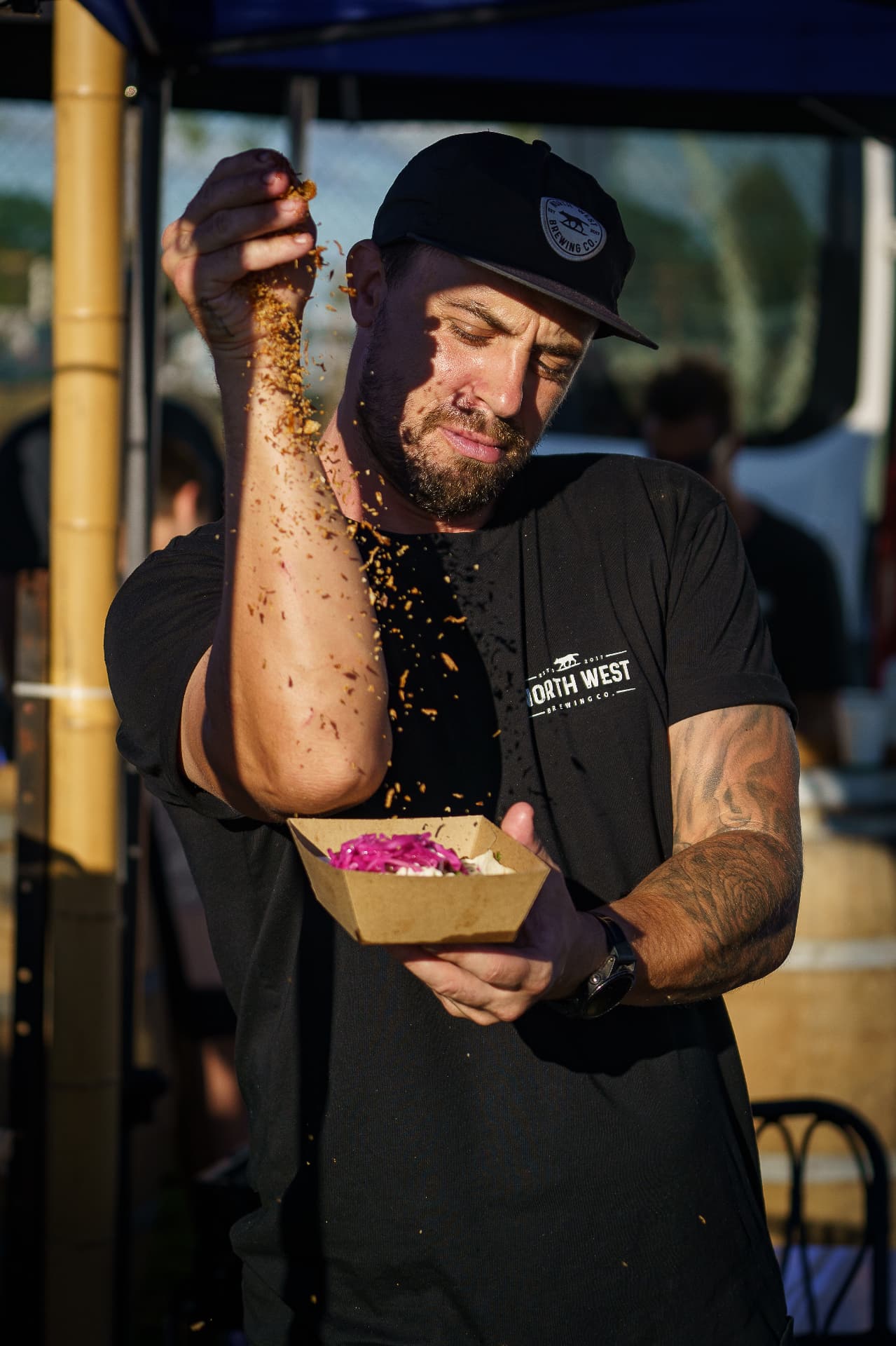 Chef sprinkling toppings on a dish