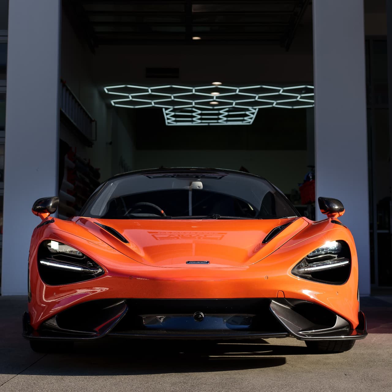 Orange McLaren 765LT front view in the workshop
